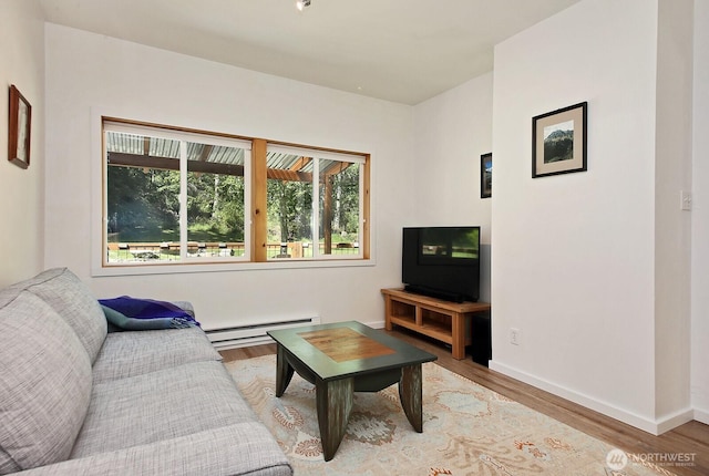 3425 Passage Way, Langley, WA 98260 - living room featuring baseboard heating, wood finished floors, and baseboards