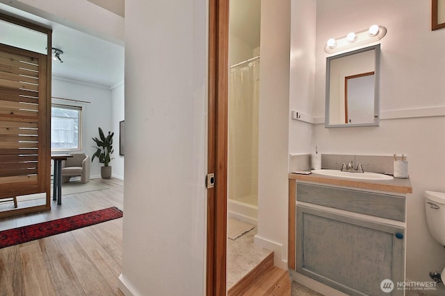 3425 Passage Way, Langley, WA 98260 - full bathroom featuring wood finished floors, vanity, curtained shower, toilet, and baseboards