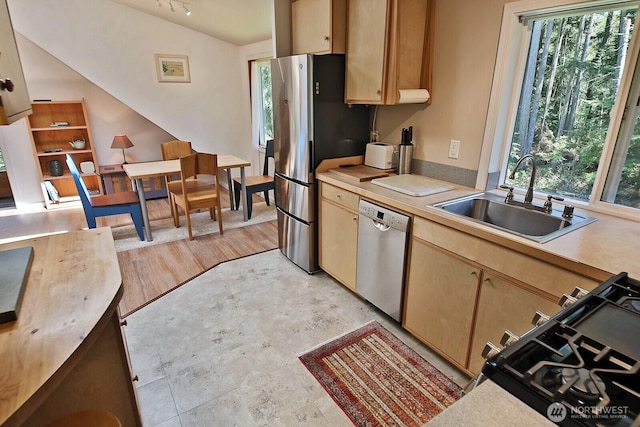 3425 Passage Way, Langley, WA 98260 - kitchen with appliances with stainless steel finishes, a sink, light countertops, lofted ceiling, and light brown cabinets