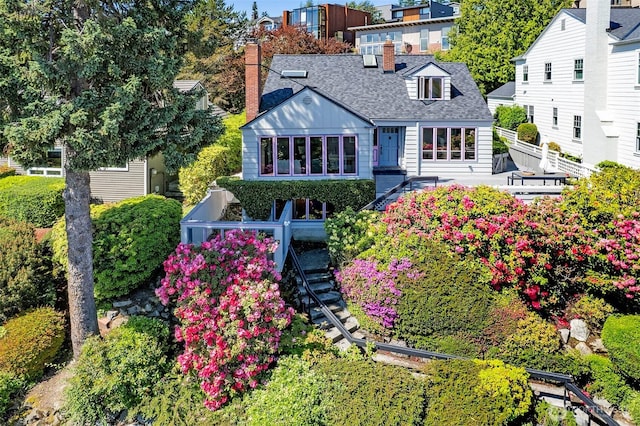 4539 E Laurel Dr NE, Seattle, WA 98105 - back of property featuring a chimney, stairway, and roof with shingles