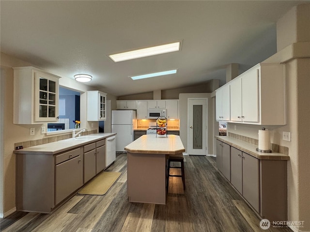 21 Cedar Hill Ln, Sequim, WA 98382 - kitchen featuring white appliances, dark wood-type flooring, a center island, and lofted ceiling