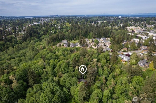aerial view of property and surrounding area with a forest