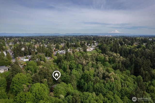 aerial view of property's location featuring a heavily wooded area