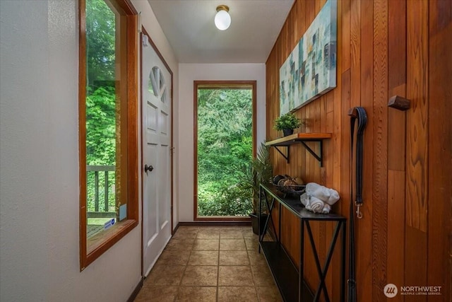 entryway featuring wooden walls