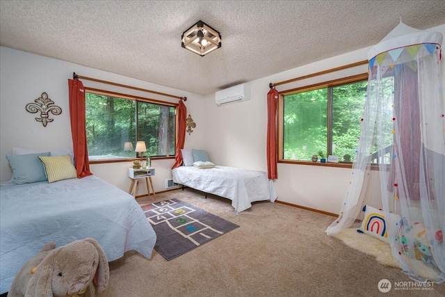 carpeted bedroom with a wall mounted AC, a textured ceiling, and baseboards