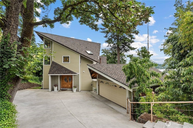 8526 E Mercer Way, Mercer Island, WA 98040 - view of front facade featuring roof with shingles, an attached garage, and driveway