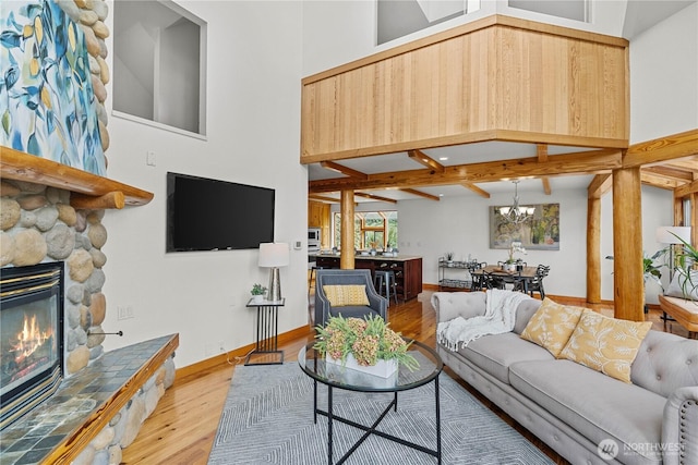 8526 E Mercer Way, Mercer Island, WA 98040 - living room featuring wood finished floors, a chandelier, and a fireplace