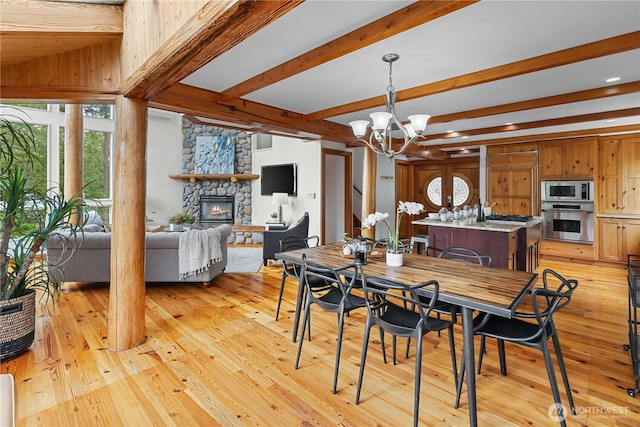 8526 E Mercer Way, Mercer Island, WA 98040 - dining room with a fireplace, a chandelier, light wood finished floors, beam ceiling, and recessed lighting