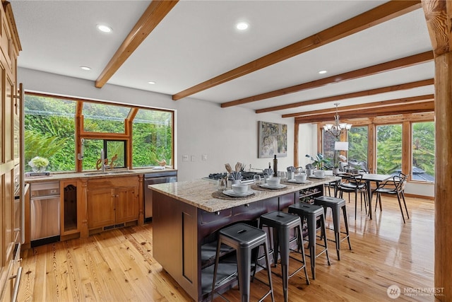 8526 E Mercer Way, Mercer Island, WA 98040 - kitchen featuring dishwasher, beamed ceiling, brown cabinets, a kitchen bar, and light wood-type flooring