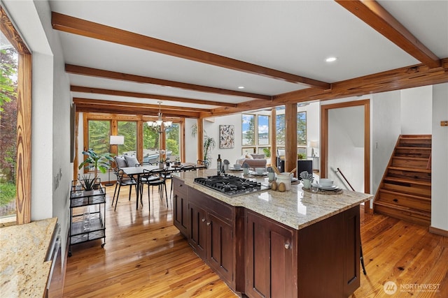 8526 E Mercer Way, Mercer Island, WA 98040 - kitchen featuring stainless steel gas stovetop, beam ceiling, a chandelier, light wood finished floors, and open floor plan