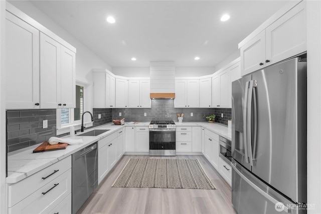 118 16th Ave, Seattle, WA 98122 - kitchen with appliances with stainless steel finishes, a sink, custom exhaust hood, backsplash, and light wood finished floors