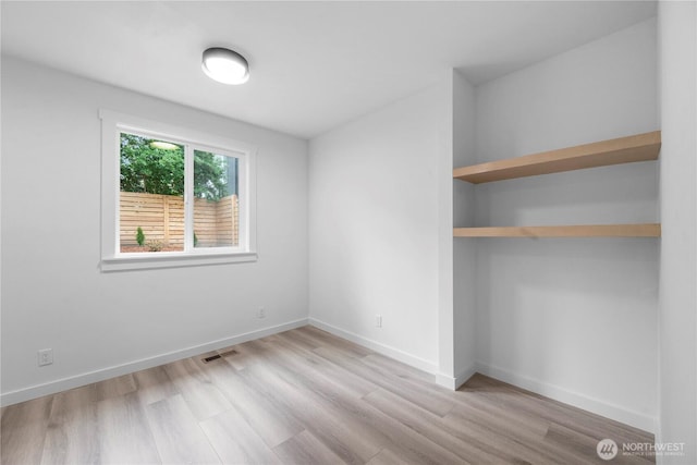 118 16th Ave, Seattle, WA 98122 - unfurnished bedroom with wood finished floors and baseboards
