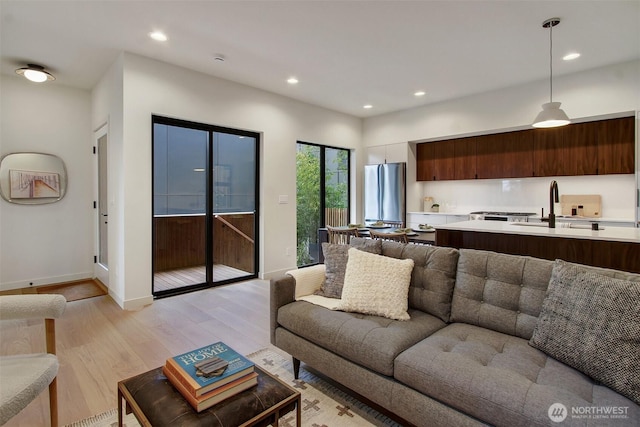 3816B 36th Ave W, Seattle, WA 98199 - living area with light wood-type flooring, recessed lighting, and baseboards