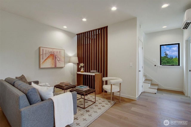 3816B 36th Ave W, Seattle, WA 98199 - living room featuring light wood-type flooring, a wall mounted AC, baseboards, stairs, and recessed lighting