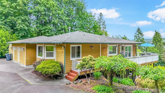 7509 145th St NW, Gig Harbor, WA 98329 - view of front of house with an attached garage, driveway, and a deck