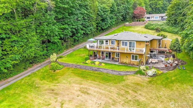 7509 145th St NW, Gig Harbor, WA 98329 - rear view of house with a patio area, a wooden deck, a lawn, and outdoor lounge area