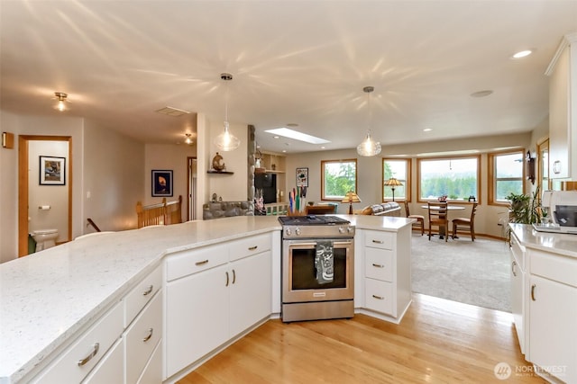 7509 145th St NW, Gig Harbor, WA 98329 - kitchen with gas range, white cabinets, decorative light fixtures, and recessed lighting
