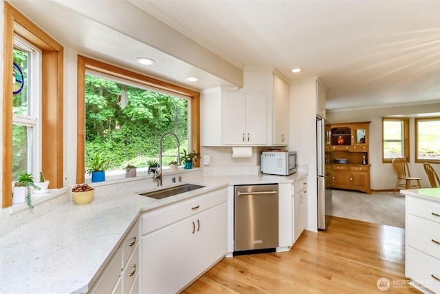 7509 145th St NW, Gig Harbor, WA 98329 - kitchen with appliances with stainless steel finishes, a sink, plenty of natural light, white cabinetry, and recessed lighting