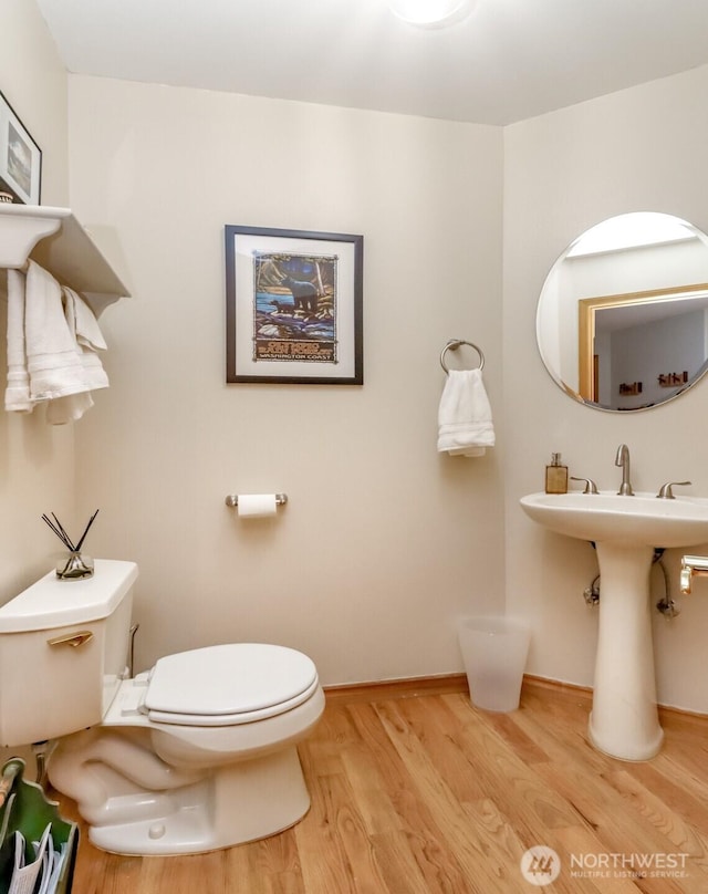 7509 145th St NW, Gig Harbor, WA 98329 - half bathroom with toilet, wood finished floors, and baseboards