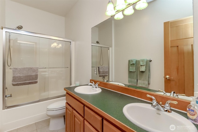 7509 145th St NW, Gig Harbor, WA 98329 - full bath with tile patterned floors, toilet, combined bath / shower with glass door, and double vanity