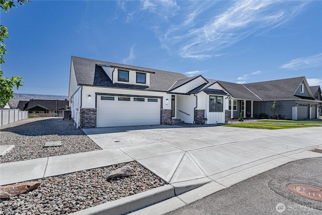 985 Spring Mountain Dr, Wenatchee, WA 98801 - view of front facade with stone siding, concrete driveway, and board and batten siding