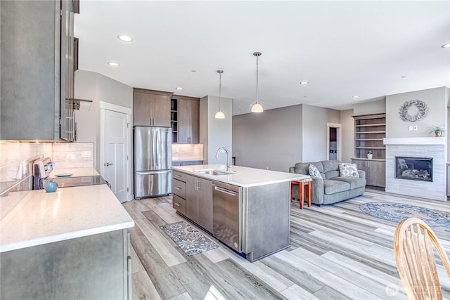 985 Spring Mountain Dr, Wenatchee, WA 98801 - kitchen with appliances with stainless steel finishes, light countertops, light wood-style flooring, backsplash, and recessed lighting