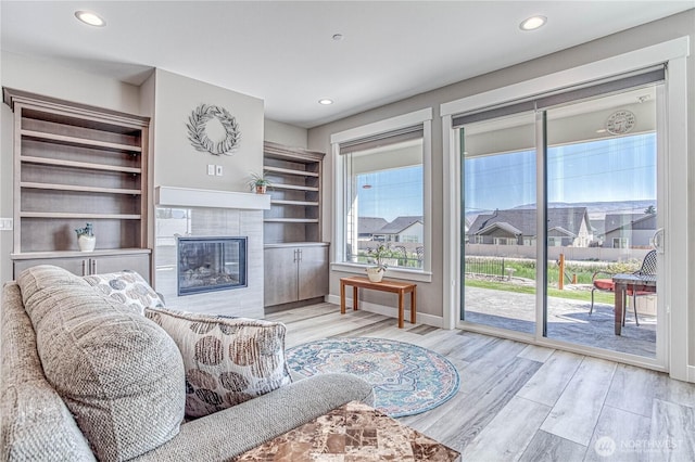 985 Spring Mountain Dr, Wenatchee, WA 98801 - living room with wood finished floors, a tiled fireplace, and recessed lighting