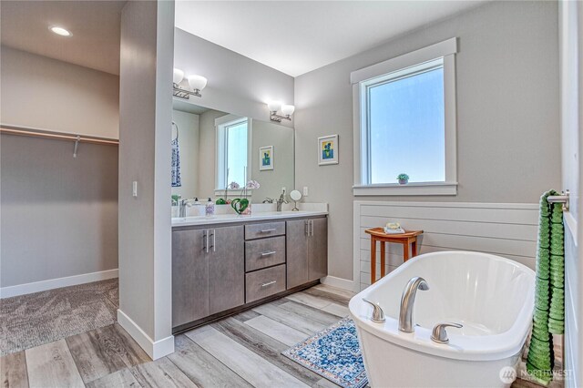 985 Spring Mountain Dr, Wenatchee, WA 98801 - full bathroom featuring a freestanding tub, plenty of natural light, wood finished floors, and double vanity