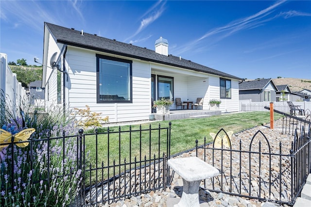 985 Spring Mountain Dr, Wenatchee, WA 98801 - rear view of house featuring a fenced backyard, a patio, and a chimney