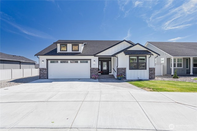 985 Spring Mountain Dr, Wenatchee, WA 98801 - view of front of home featuring stone siding, concrete driveway, board and batten siding, and roof with shingles