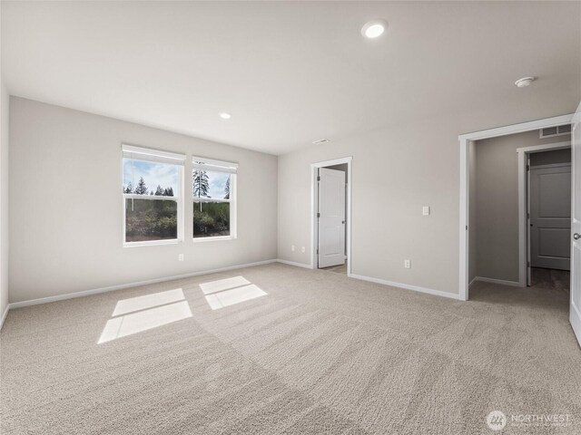 28305 74th Dr NW Unit 89, Stanwood, WA 98292 - unfurnished bedroom with light carpet, baseboards, and recessed lighting
