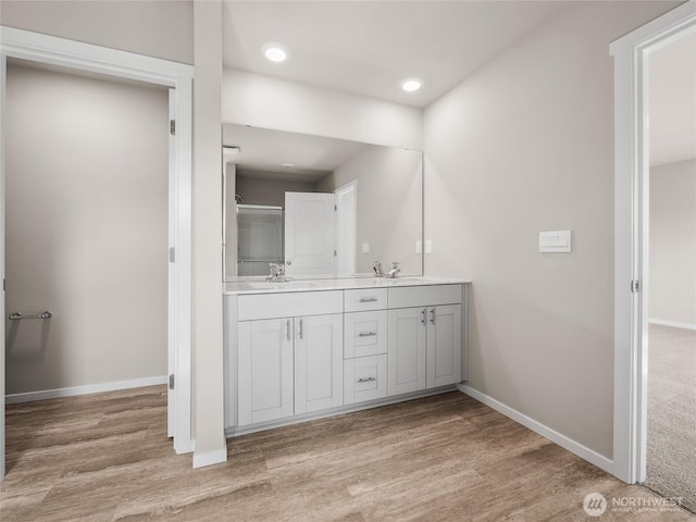 28305 74th Dr NW Unit 89, Stanwood, WA 98292 - full bathroom featuring double vanity, wood finished floors, baseboards, and recessed lighting