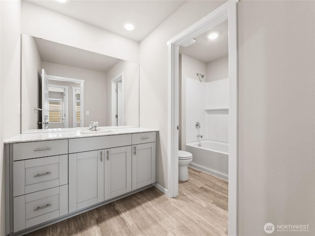 28305 74th Dr NW Unit 89, Stanwood, WA 98292 - full bathroom featuring wood finished floors, vanity, toilet, bathtub / shower combination, and baseboards