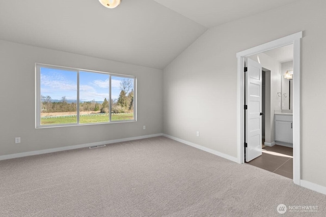 17705 11th Ave NE, Arlington, WA 98223 - unfurnished bedroom with carpet, lofted ceiling, baseboards, and ensuite bath