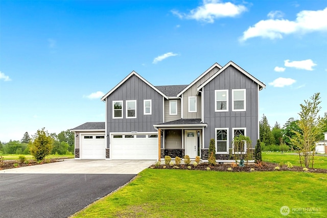 17705 11th Ave NE, Arlington, WA 98223 - view of front of house featuring board and batten siding, asphalt driveway, a front yard, and a garage