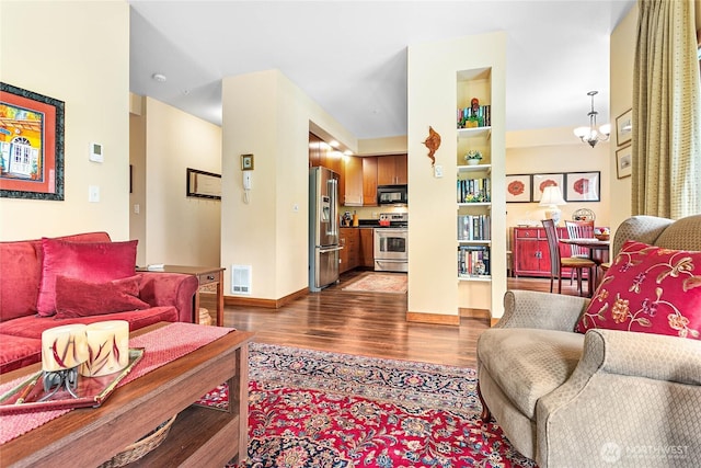 4631 Quinn Ct Unit 101, Bellingham, WA 98226 - living room with dark wood-type flooring, a chandelier, and baseboards