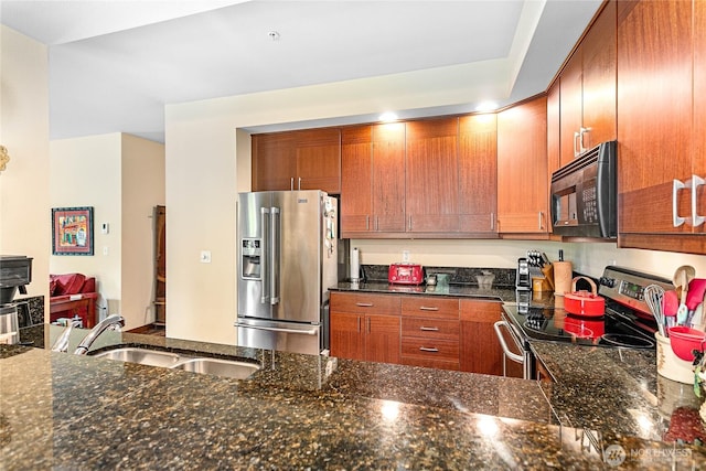 4631 Quinn Ct Unit 101, Bellingham, WA 98226 - kitchen featuring stainless steel appliances, a sink, brown cabinetry, and dark stone countertops