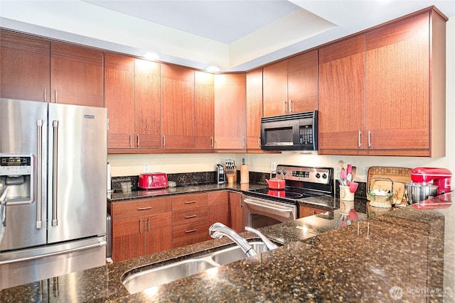 4631 Quinn Ct Unit 101, Bellingham, WA 98226 - kitchen featuring stainless steel appliances, a sink, dark stone counters, and brown cabinets