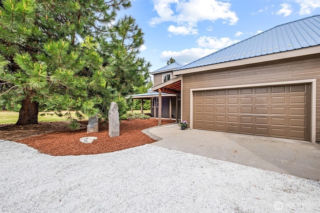 12111 W Shugart Flats Rd, Leavenworth, WA 98826 - view of home's exterior with metal roof, driveway, and an attached garage