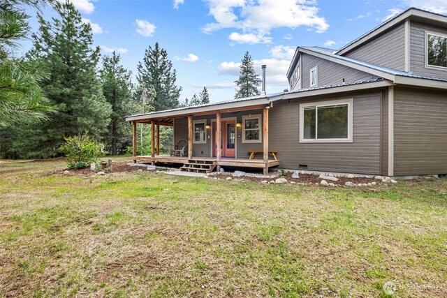 12111 W Shugart Flats Rd, Leavenworth, WA 98826 - back of house featuring a yard, covered porch, metal roof, and crawl space