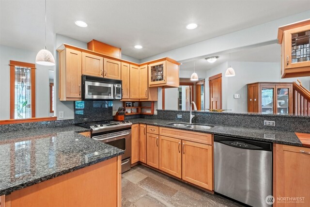 12111 W Shugart Flats Rd, Leavenworth, WA 98826 - kitchen with stainless steel appliances, a sink, a peninsula, decorative light fixtures, and dark stone countertops