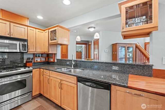 12111 W Shugart Flats Rd, Leavenworth, WA 98826 - kitchen with appliances with stainless steel finishes, a sink, light brown cabinetry, glass insert cabinets, and dark stone countertops