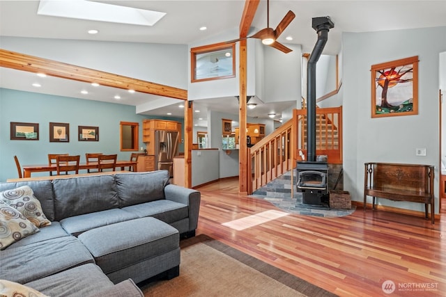 12111 W Shugart Flats Rd, Leavenworth, WA 98826 - living area with a wood stove, light wood-type flooring, a skylight, stairs, and recessed lighting