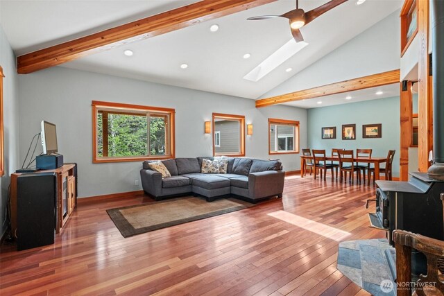 12111 W Shugart Flats Rd, Leavenworth, WA 98826 - living room featuring beam ceiling, a skylight, light wood-style flooring, baseboards, and ceiling fan