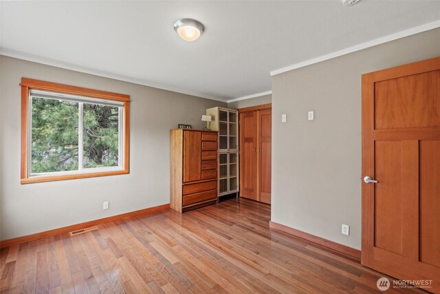 12111 W Shugart Flats Rd, Leavenworth, WA 98826 - unfurnished room with baseboards, light wood-style flooring, and crown molding