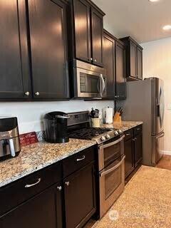 13807 63rd Ave E, Puyallup, WA 98373 - kitchen with stainless steel appliances, light stone counters, recessed lighting, and baseboards