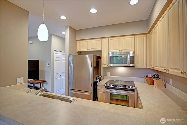 13000 Admiralty Way Unit A305, Everett, WA 98204 - kitchen featuring appliances with stainless steel finishes, a sink, light brown cabinetry, recessed lighting, and light countertops
