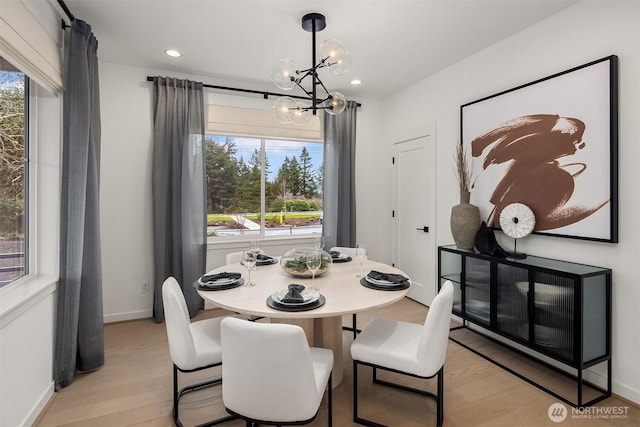dining room with a chandelier, light wood-style floors, baseboards, and recessed lighting