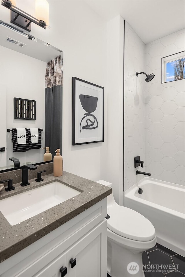 full bathroom with toilet, vanity, and bathtub / shower combination