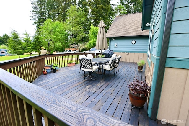 wooden deck with outdoor dining space